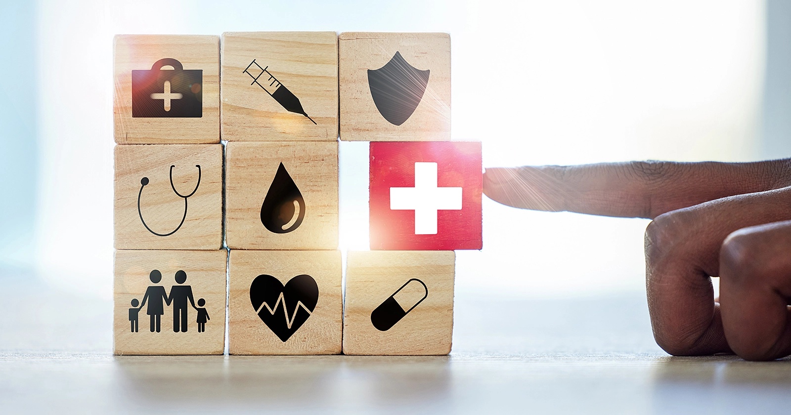 Conceptual photo of blocks with various healthcare related symbols.
