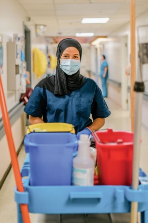 Housekeeping A staff member with cleaning supplies