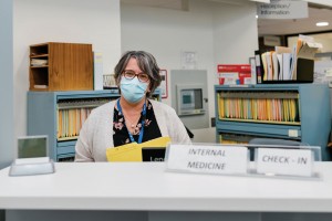 Internal Medical Check-in Staff member at a desk in the hospital